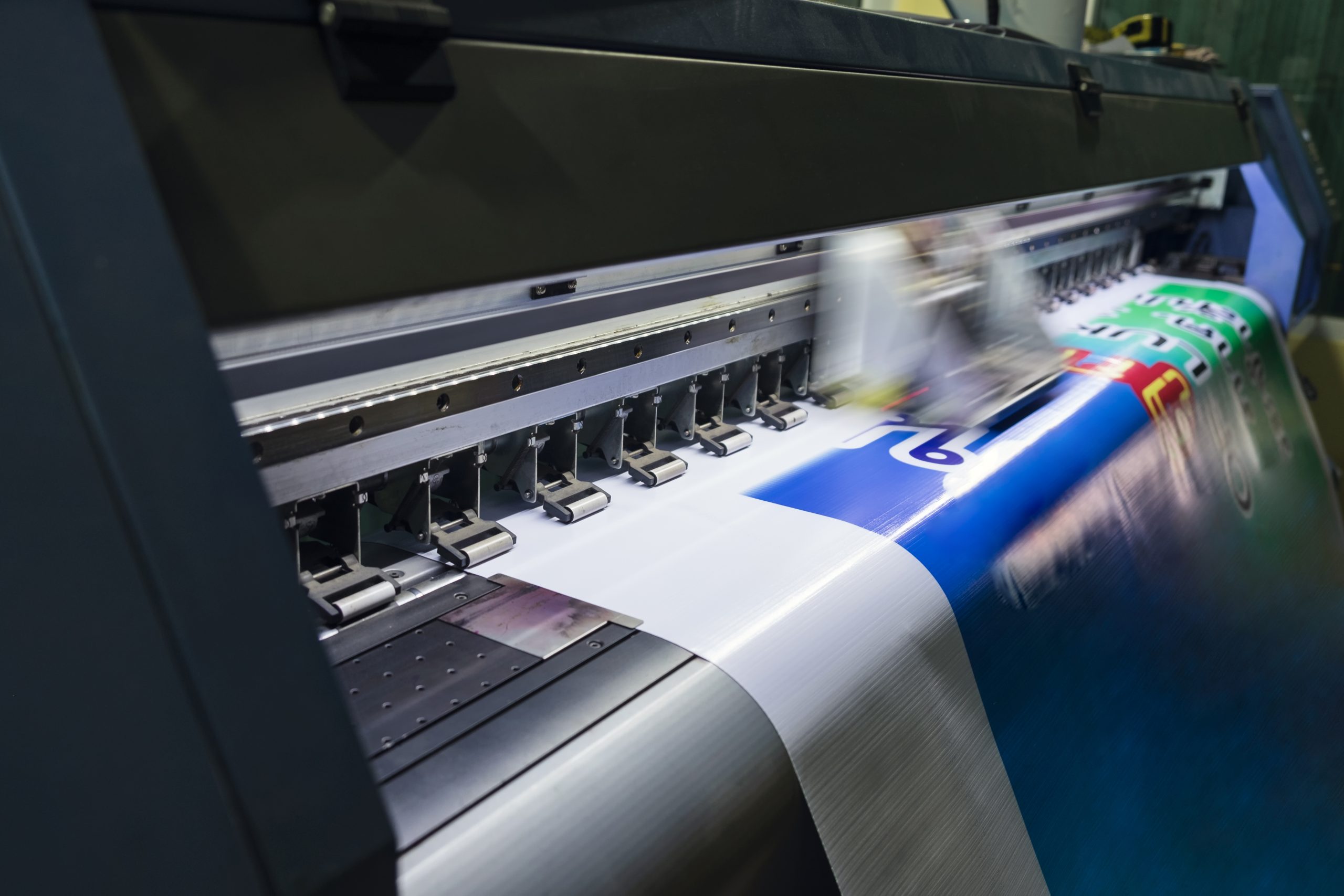 large format inkjet printer working on vinyl paper in workplace
